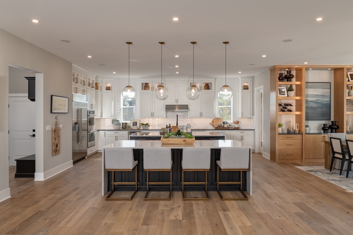 modern kitchen with dual waterfall islands and glass pendant lighting