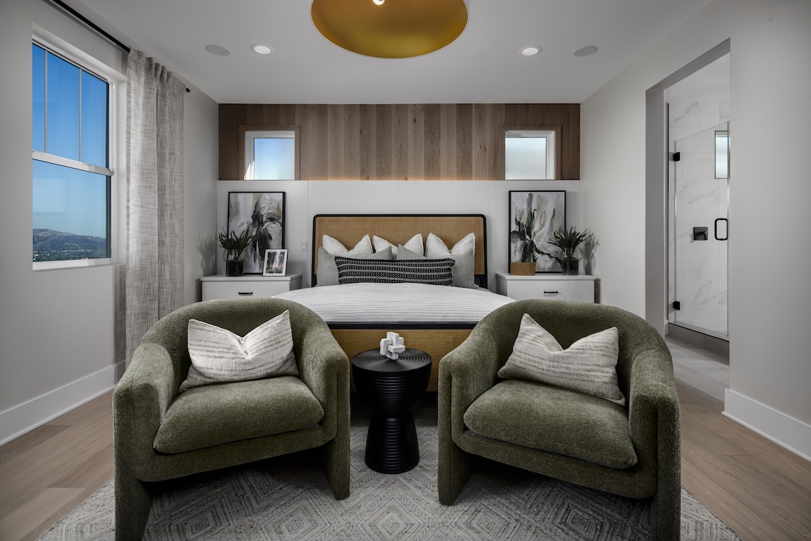 primary bedroom with accent wall and lighting