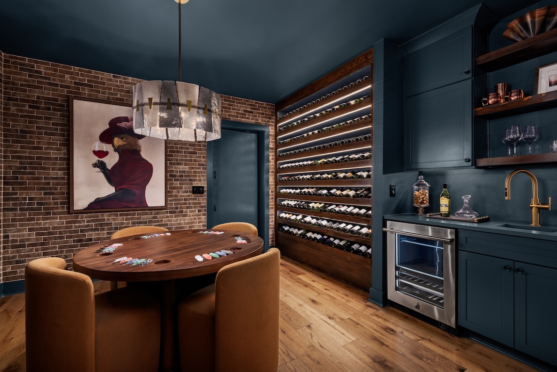 game room with a brick accent wall and built in bar