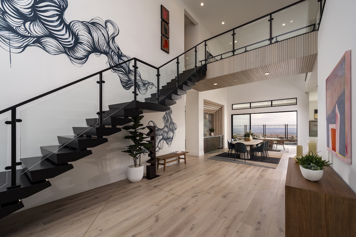 entryway with accent wall and floating staircase