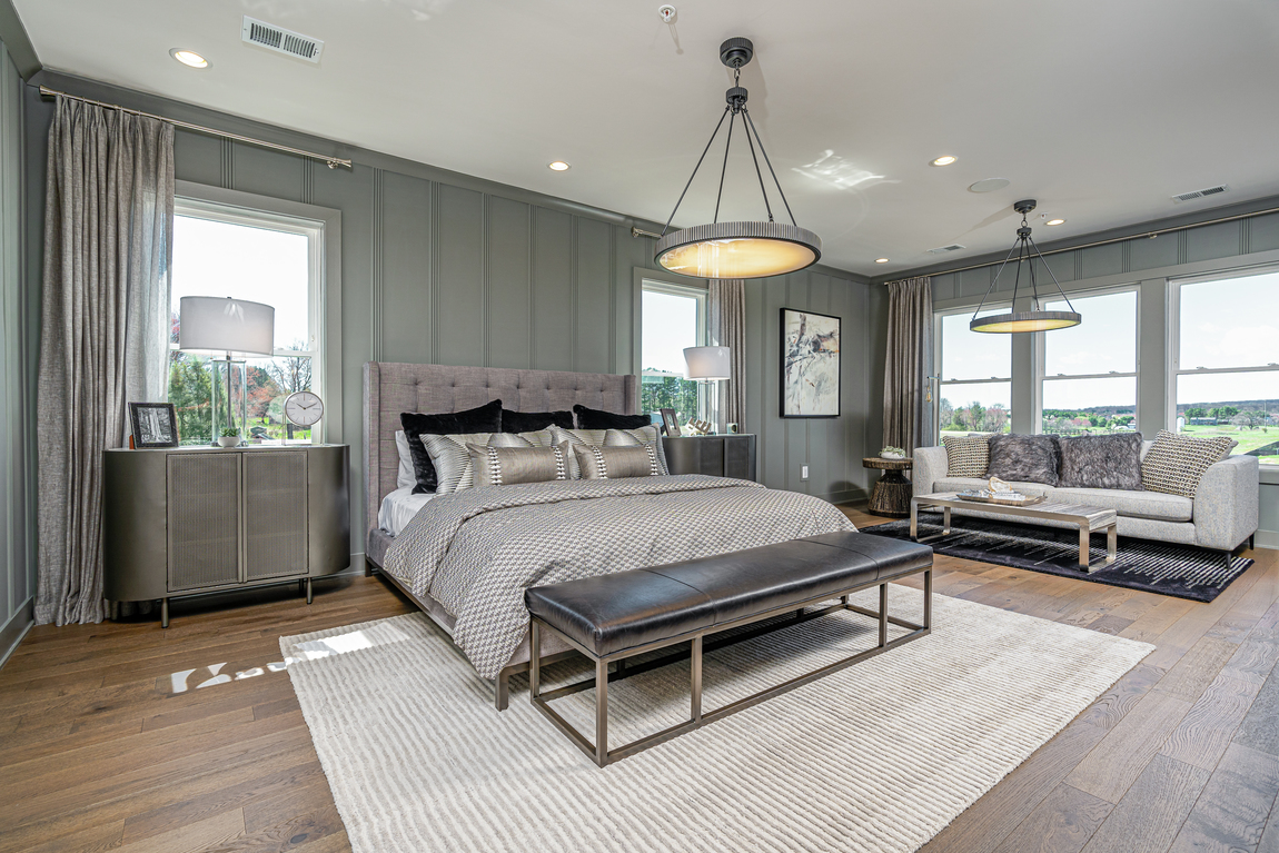 Gray master bedroom with lounge area