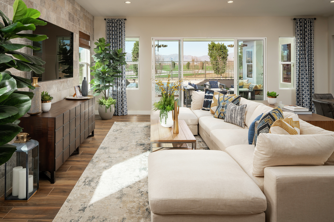 Living room highlighted by blue and green accent colors, hues used in popular design trends.