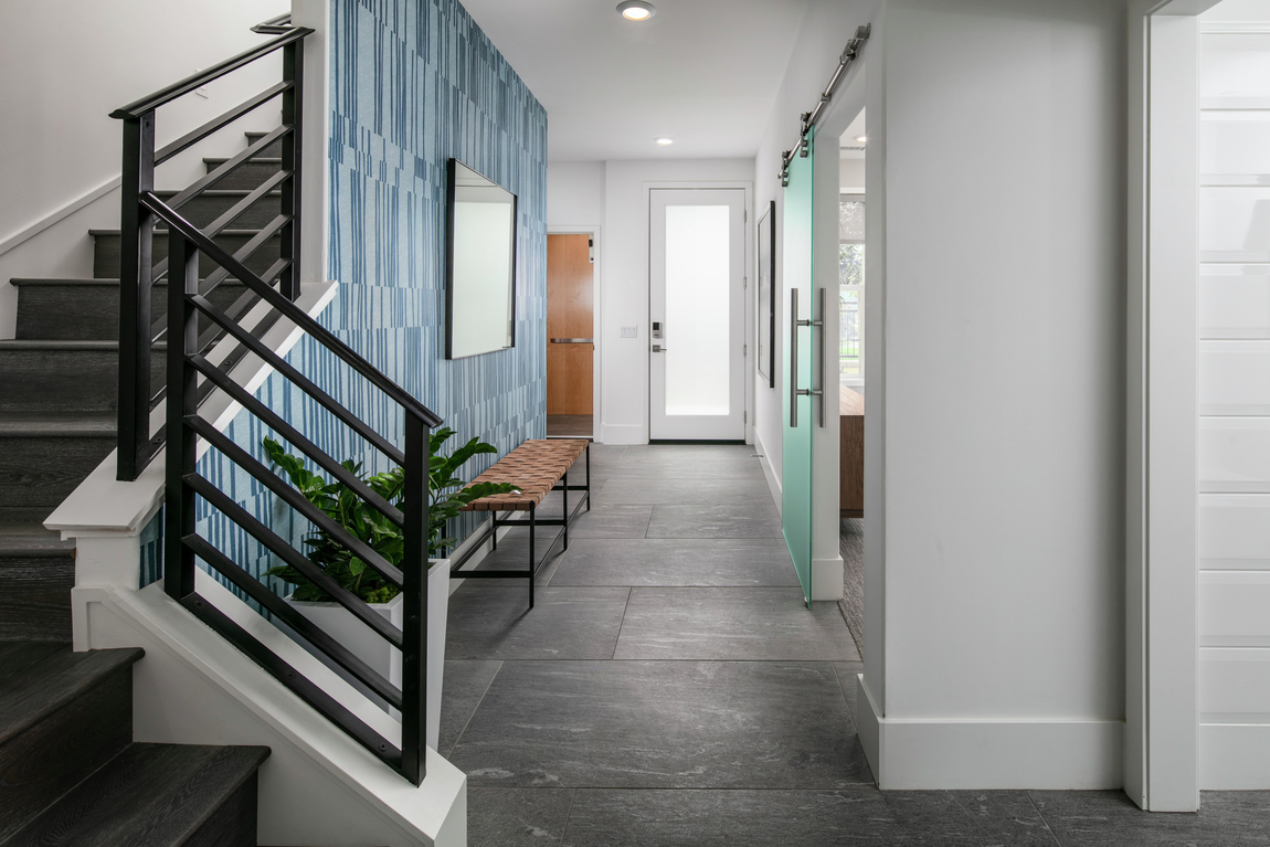 Entry featuring a pleasing shae of blue accent wall
