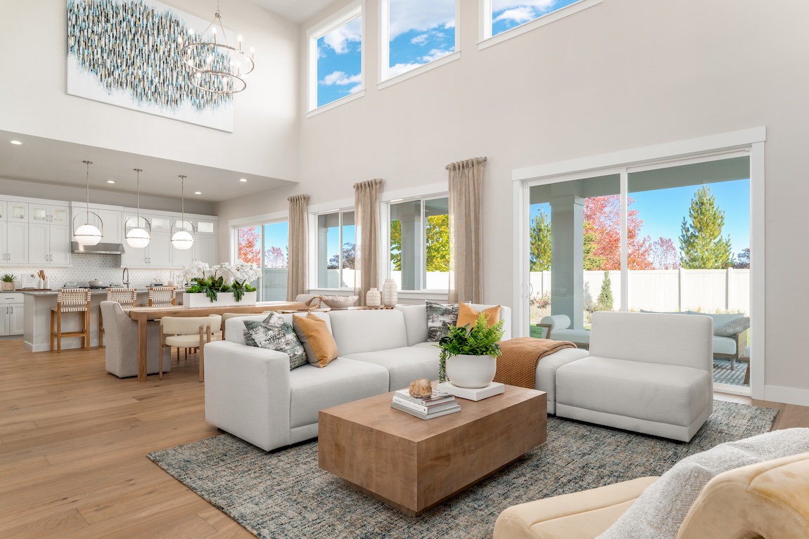 open-concept living space with sectional couch and access to the outdoor living area