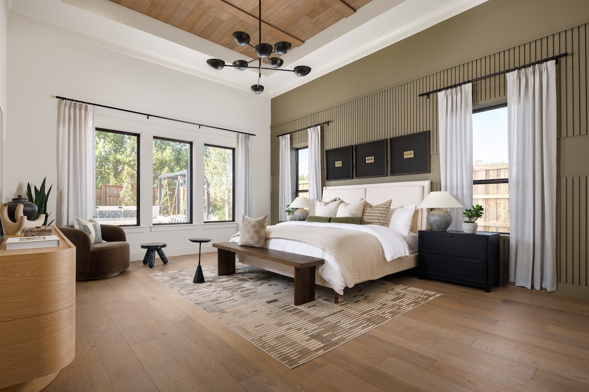 primary bedroom with green accent wall