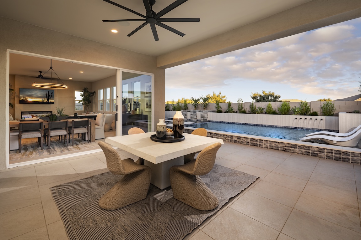 outdoor living space with sliding glass doors and a dining table