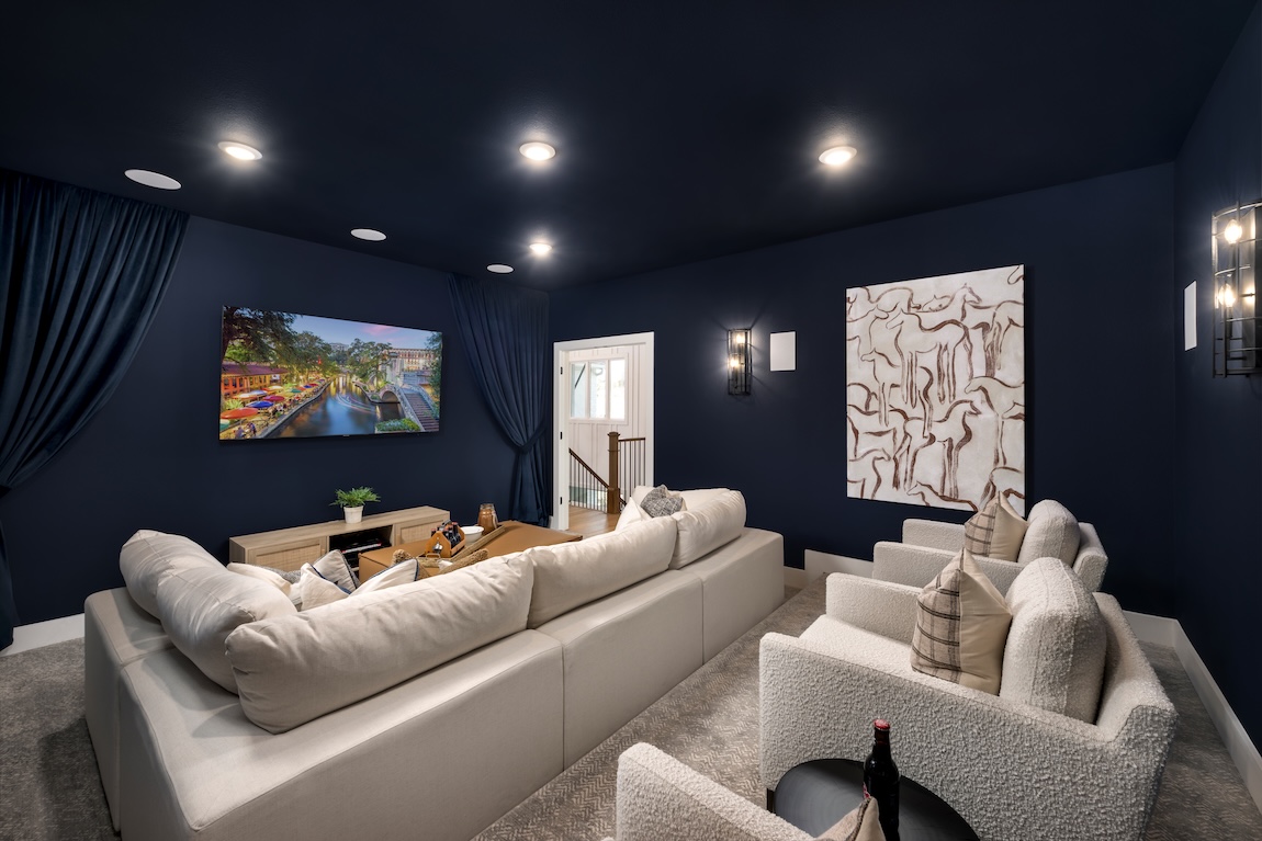 home theater with couches and a TV