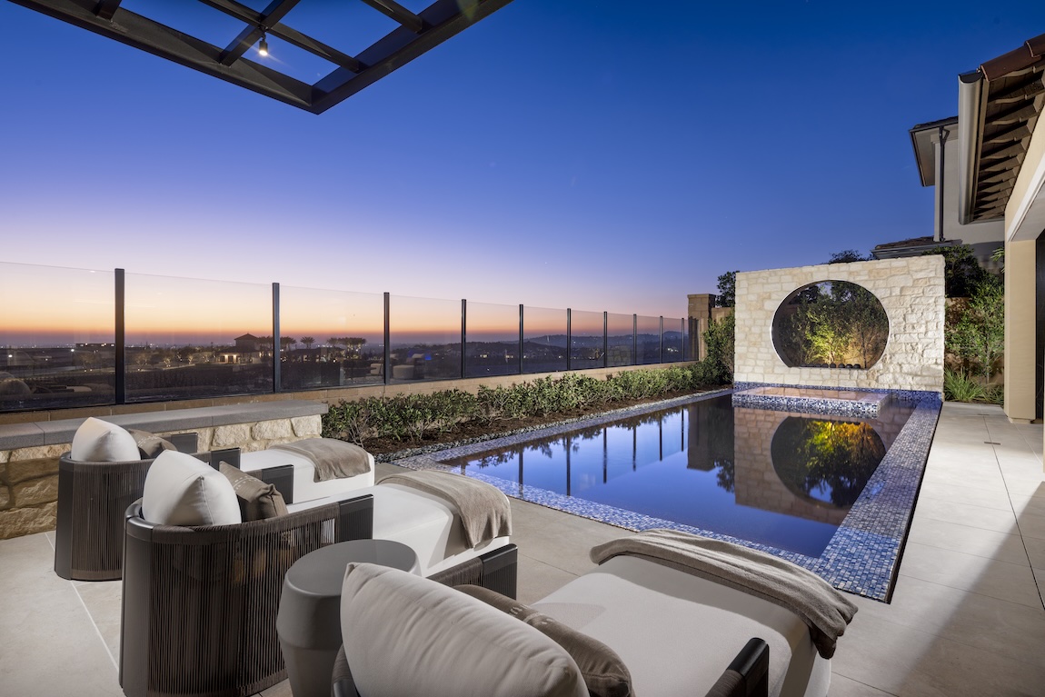 outdoor living space with pool and lounge chairs.