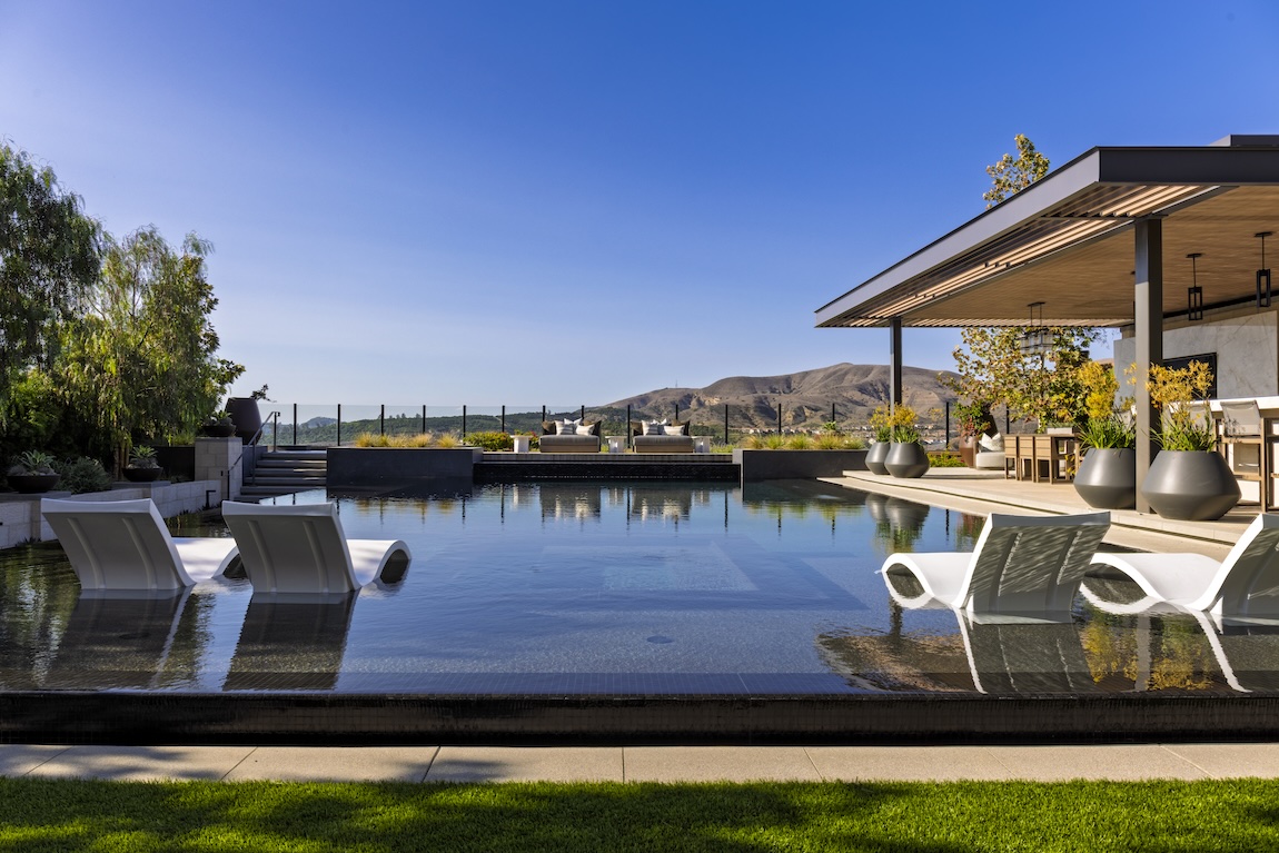 backyard retreat with pool and lounge spaces