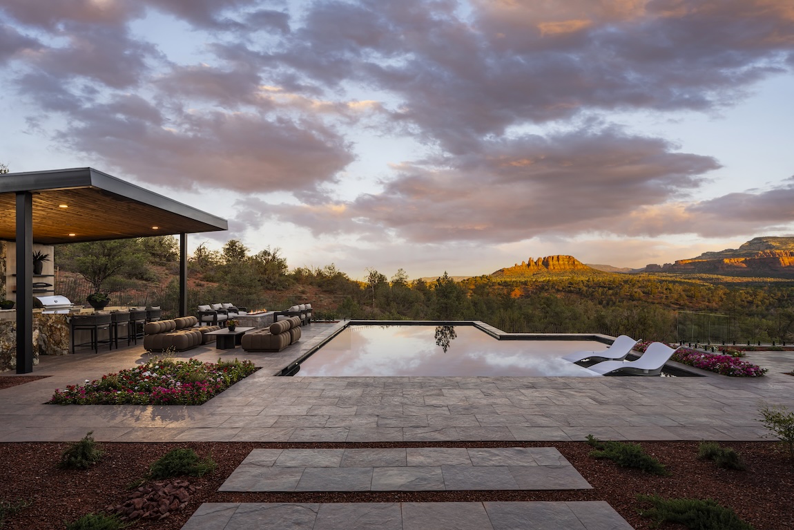 Outdoor living space with a gazebo and pool overlooking the mountains.