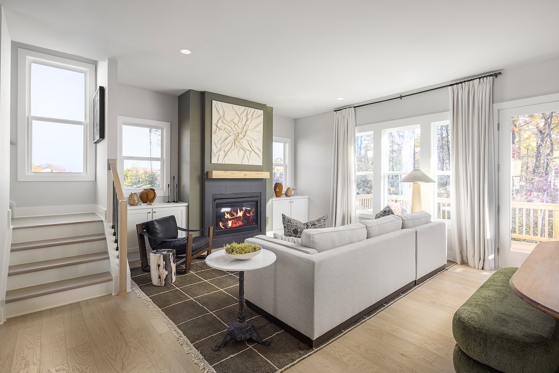 Luxury living room design with green fireplace mantle and white couch.