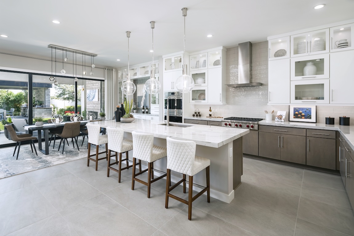 modern kitchen island and dining area leading out to the outdoor living space.