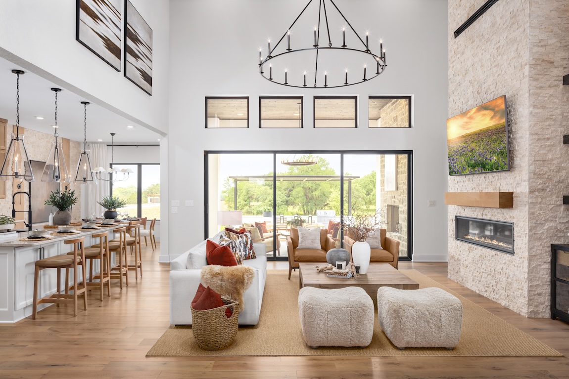 Luxe great room with ample natural lighting and two-story ceilings