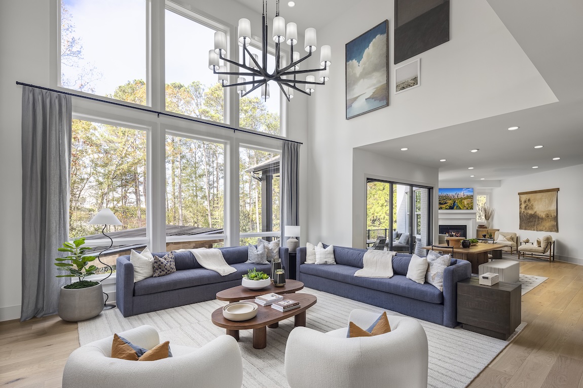 Two-story great room with expansive windows and ample natural lighting