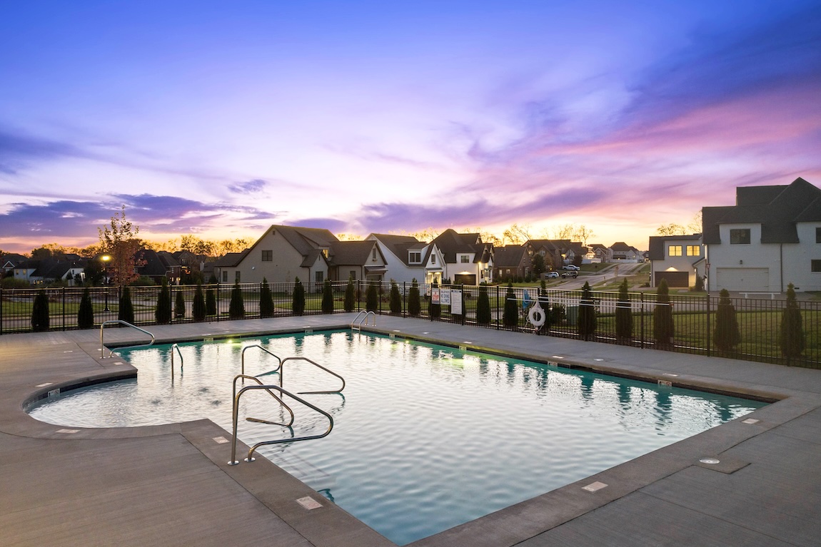 community pool looking over the community and sunset in the sky