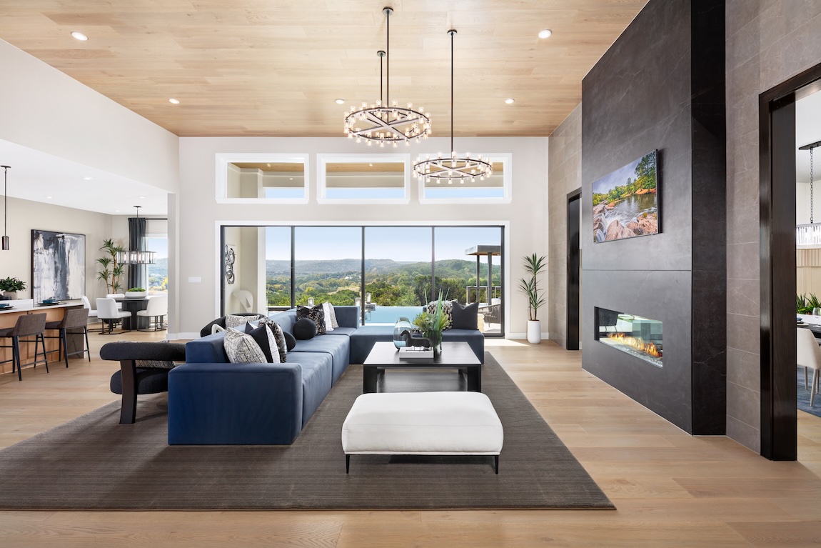 Spacious great room with modern finishes, panoramic views, and floor-to-ceiling windows.