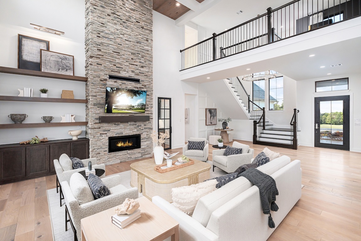 living room with stone fireplace and open-concept floor plan