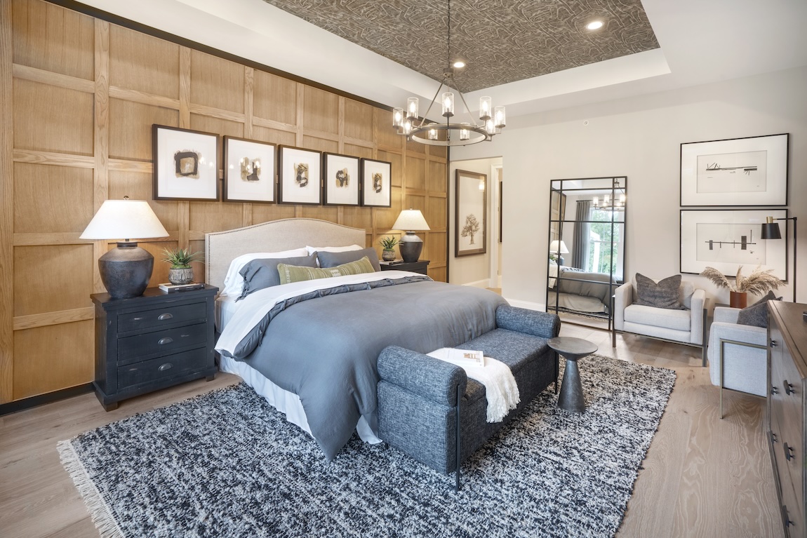 modern primary bedroom with wood accent wall