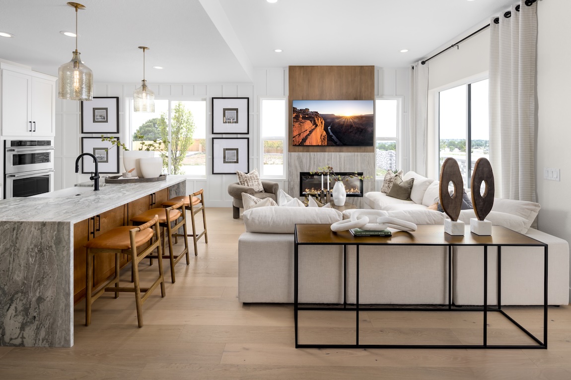 modern living room and kitchen with waterfall island and pendant lights