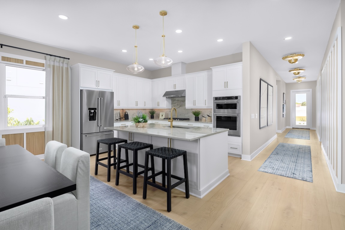 modern kitchen with glass pendant lights and island seating