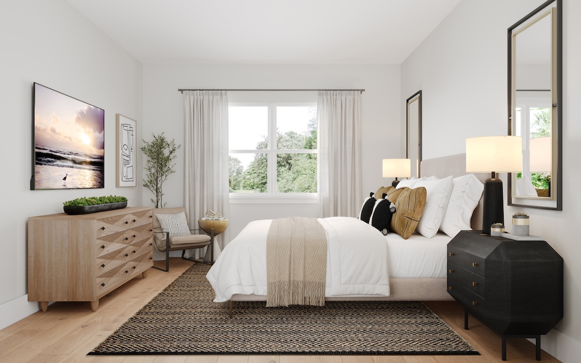 Primary bedroom with upholstered bed, wood dresser, textured area rug, and layered neutral bedding.