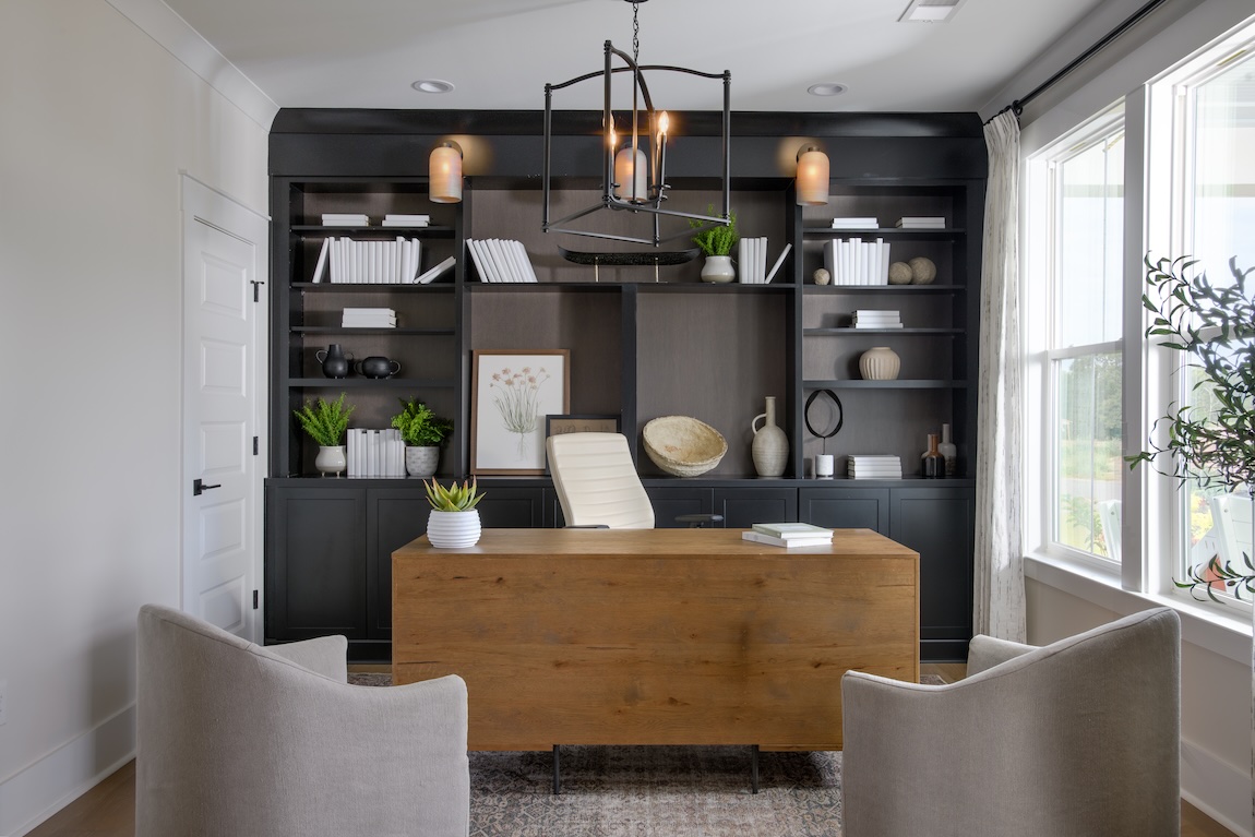 modern home office with black built-in shelving.
