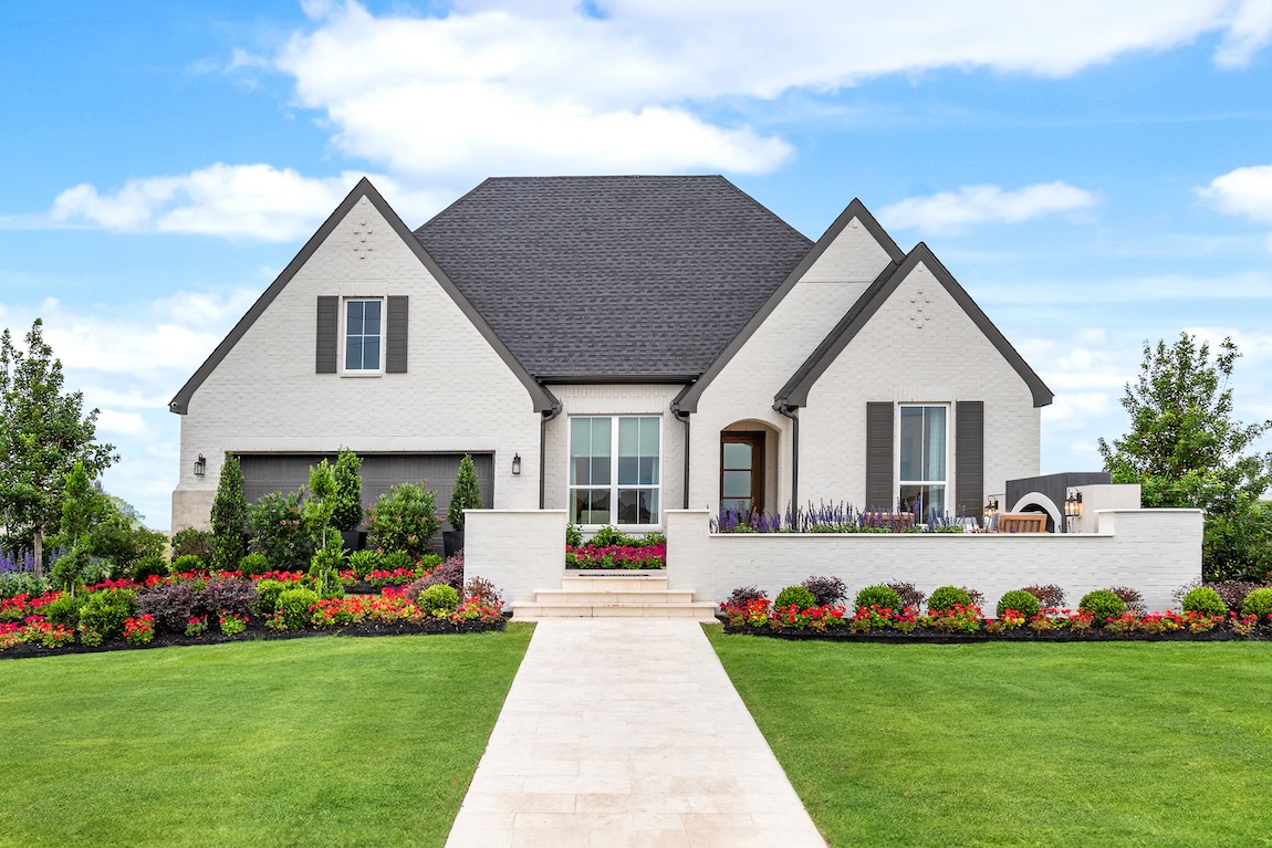 exterior of home with porch area and beautiful landscaping
