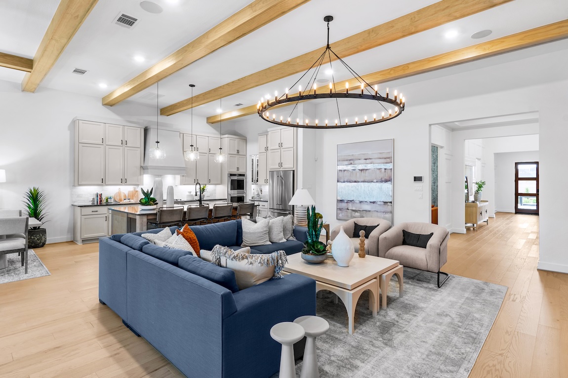 Luxury great room with colorful furniture and open-concept living connecting to the kitchen.