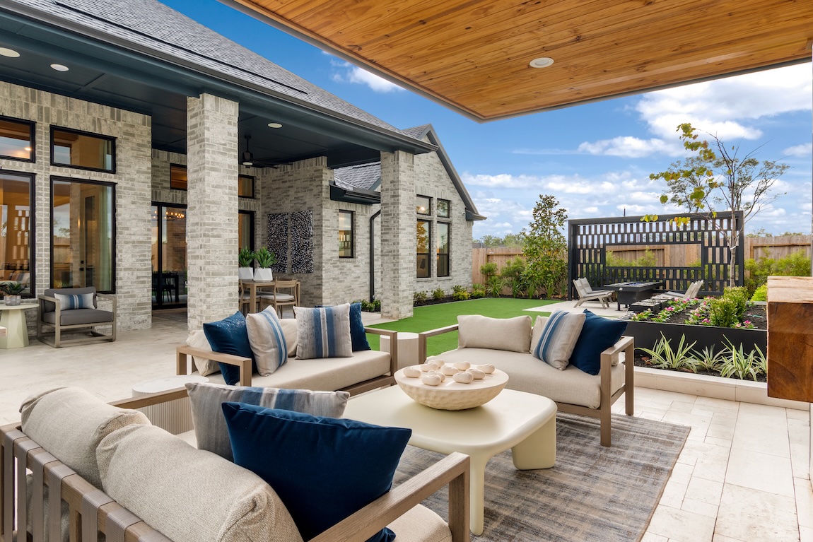 outdoor living space with seating spaces and wooden pergola.