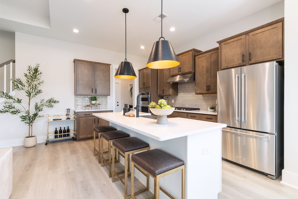 modern kitchen with wooden cabinetry and matte black lights