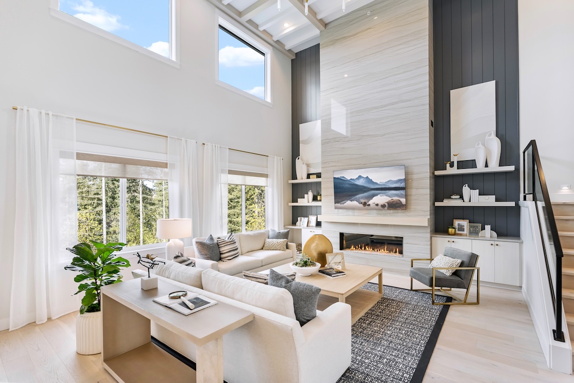 Great room with white sofas and fireplace setting