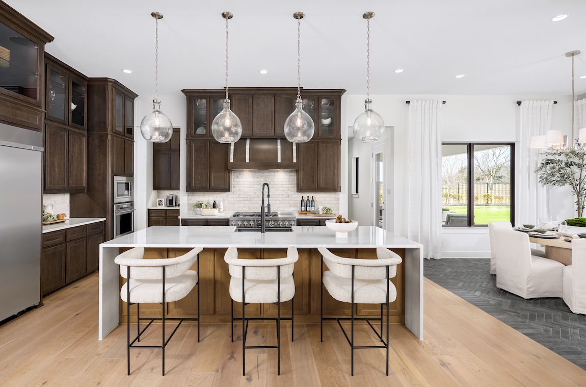 modern kitchen with waterfall island and wooden cabinets